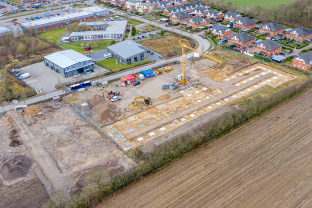 istock Drone image of a large construction site on which the concrete foundation for the columns of a factory building is being cast 1208623815