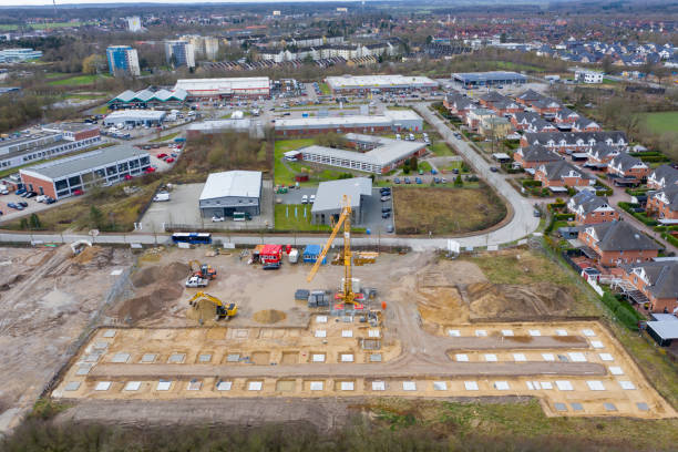 istock Drone image of a large construction site on which the concrete foundation for the columns of a factory building is being cast 1208623816