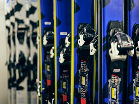 Winter sport equipment skis and boots on the shelf in the rental area of a ski resort.