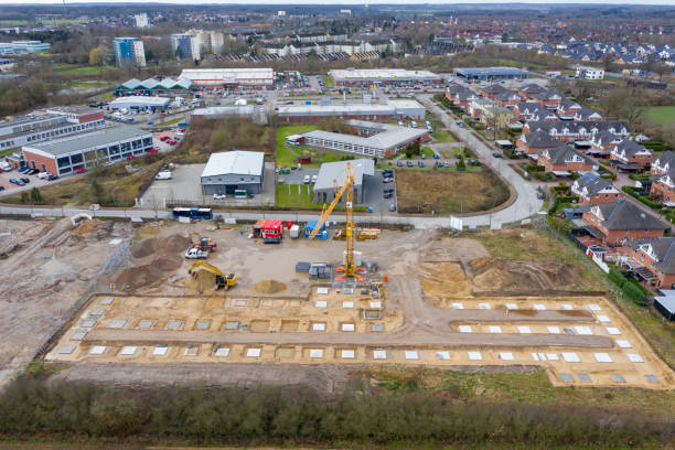 istock Drone image of a large construction site on which the concrete foundation for the columns of a factory building is being cast 1208623848