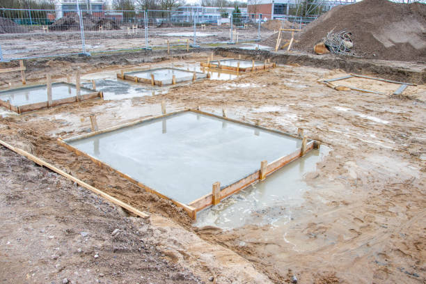 istock concrete foundations for the columns of a factory building are poured on a large construction site 1208623893