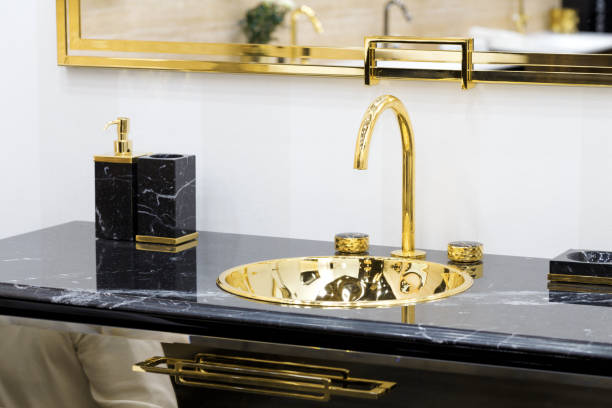 istock Bathroom interior sink and golden faucet. 1208624069