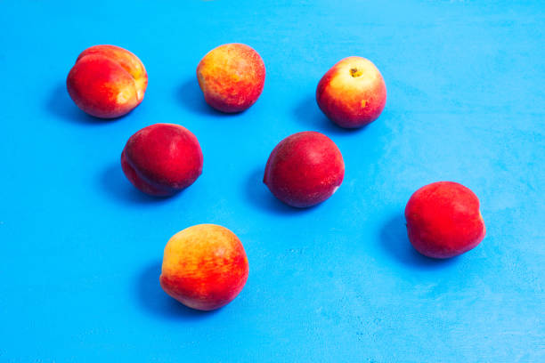 Peaches close-up on a blue background. Summer fruits.