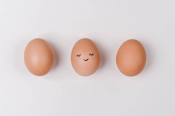 istock Creative easter eggs with cute face and sleepy eyes on pastel beige background. Happy Easter concept. 1208625286