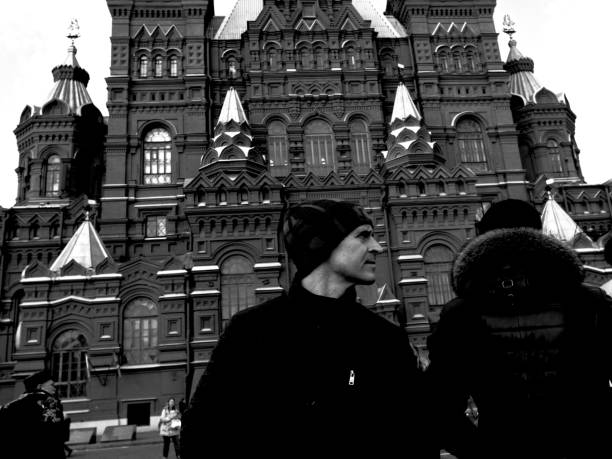 Street musicians play on Stary Arbat street next to a sightseeing bus in Moscow: Moscow, Russia - August 03, 2022