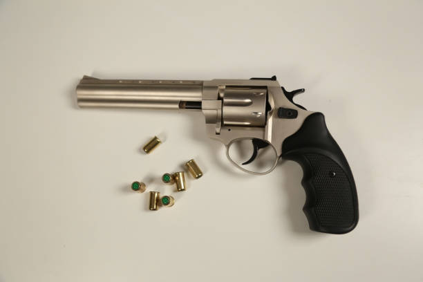 istock Pistol and Bullets on White Background 1208631201