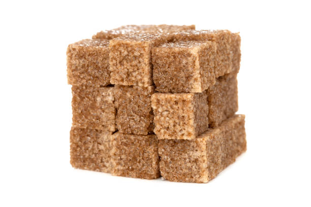 istock Cane sugar on a white background. Cane sugar cubes close up. 1208631404