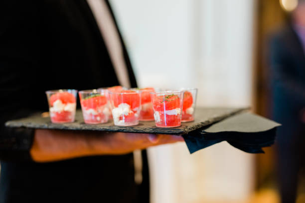 istock Waiter carrying hors d'oeuvre on a plate 1208632050