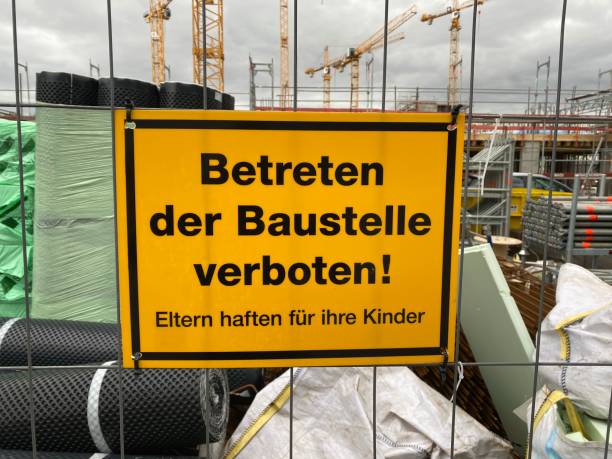 istock German sign: Building Site, do not enter, parents are responsible for their children 1208633072