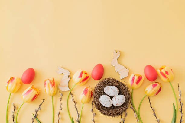 istock Flat lay easter composition with yellow tulips and eggs on a yellow background 1208633903