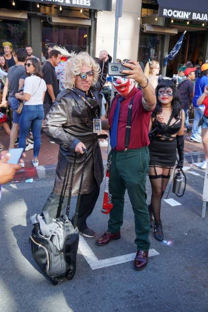 People wearing costumes, taking photos in the street next to the San Diego Comic-Con International People wearing costumes, taking photos in the street next to the San Diego Comic-Con International, Comic book convention in San Diego, California, United States. July 23rd, 2019 action anime movies stock pictures, royalty-free photos & images