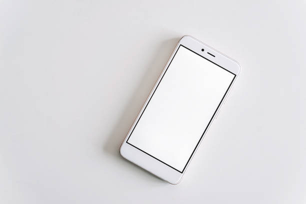 istock White mobile smartphone mockup lies on the surface with blank screen isolated on white background, usable for your web project or design presentation. 1208634840