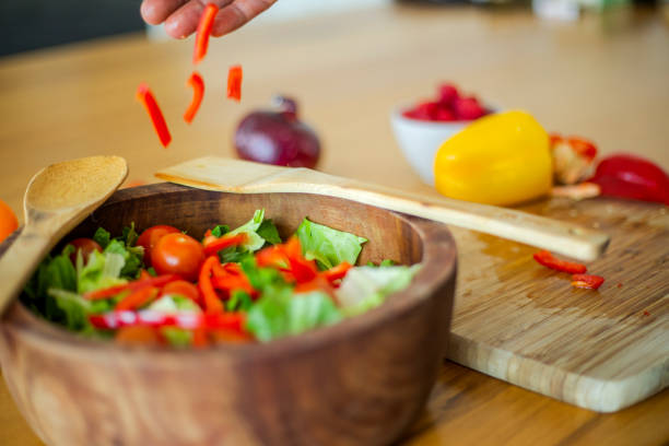 Couple preparing salad at home