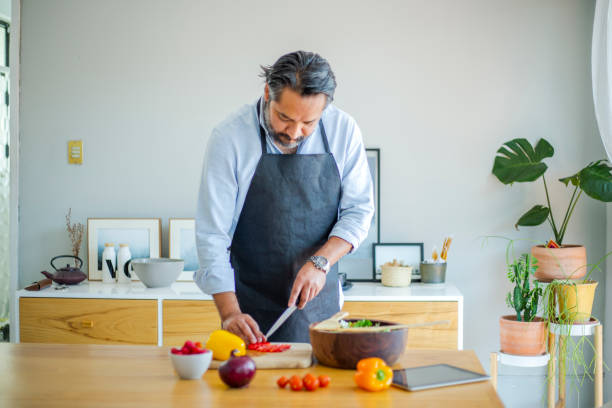 istock Couple making salad at home 1208635167