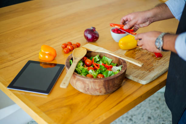 istock Couple making salad at home 1208635240