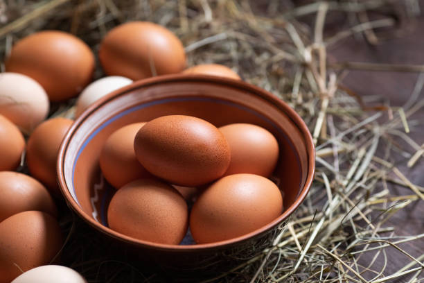istock Organic food. Bowl with chicken eggs on hay 1208636858