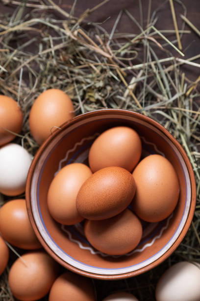 istock Organic food. Bowl with chicken eggs on hay 1208637188