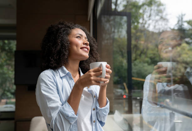 istock Thoughtful woman drinking a cup of coffee at home 1208637264