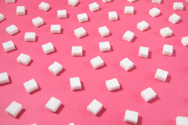 istock Pattern Made of White Sugar Cubes on Pink Background 1208637827