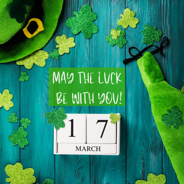 St Patrick Day dark green background with calendar St Patrick Day dark green wooden rustic background with shamrocks and leprechaun costume accessories, date march 17 on vintage wooden calendar. May the luck be with you text quote number 17 stock pictures, royalty-free photos & images