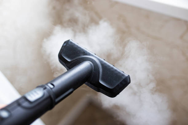steam cleaner for cleaning the house, steam erupts from the brush. stock photo