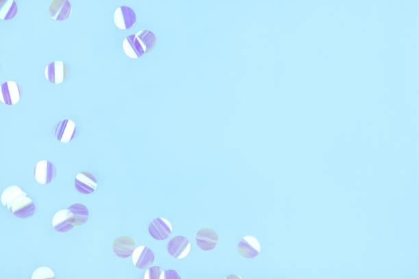 istock Pearl confetti on blue background. 1208638555