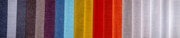 Rainbow clothes background. Pile of bright folded clothes