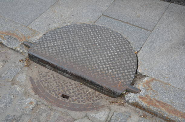 istock curb with sewer or manhole cover and sidewalk 1208639596