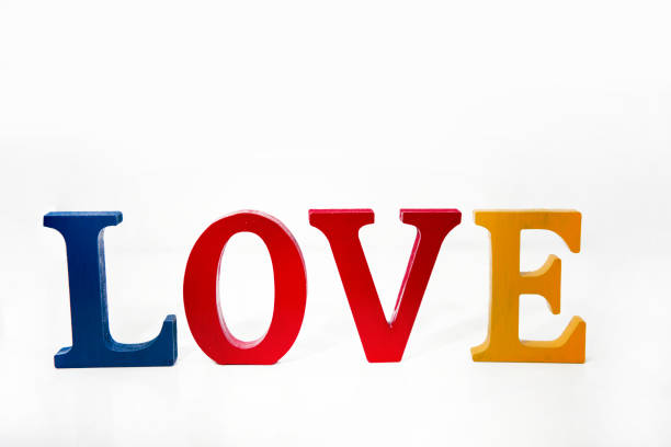 Love colored wooden letters on white background.