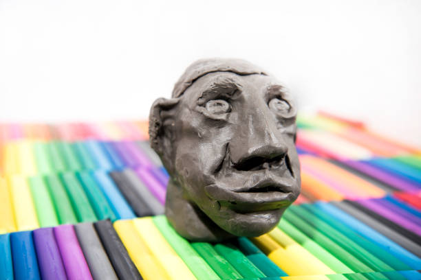 Play clay Animals. Human face on colored background.