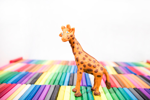 Play clay Animals. Giraffe on colored background.