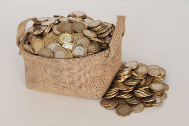 istock Glass Jar full of Mexican coins 1208643441