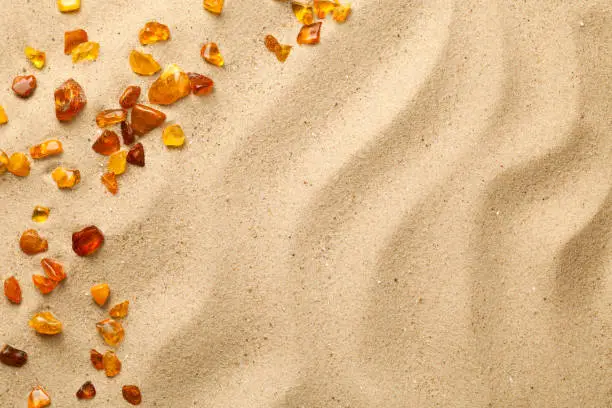 Photo of Sand Background With Scattered Ambers