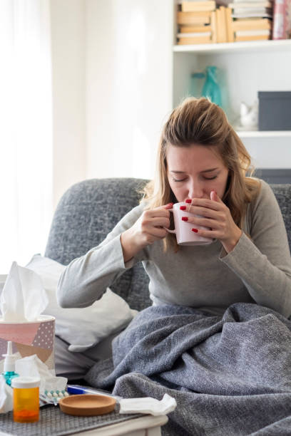 istock Sick woman with flu at home 1208649000