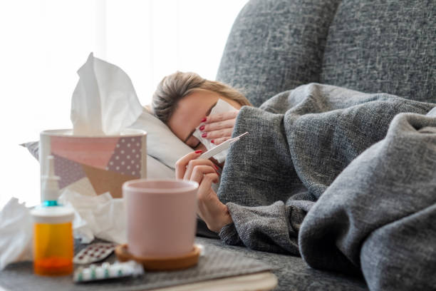 istock Sick woman with flu at home 1208649014