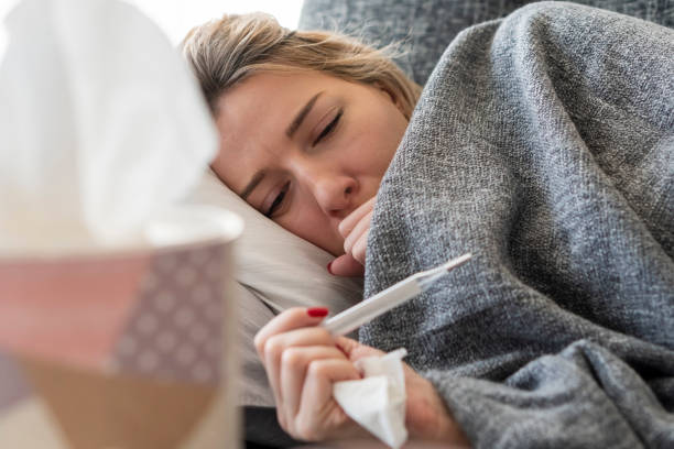 Sick woman with flu at home stock photo