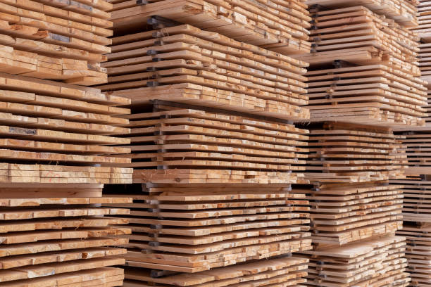 istock large stacks of wooden planks full frame background with selective focus and linear perspective 1208649418