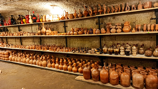 Rustic handmade brown terracotta vases and cups at the pottery shop in Avanos. Ceramic clay souvenirs at handycraft market in Cappadocia, Turkey