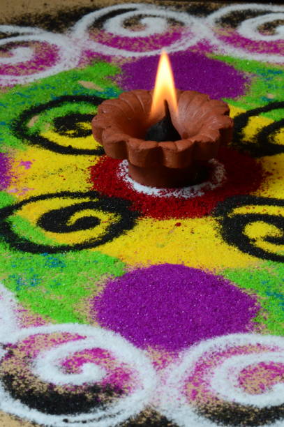 istock Clay diya lamps lit during diwali celebration, Rangoli in background 1208652539