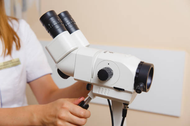 istock woman gynecologist working with colposcope 1208654836