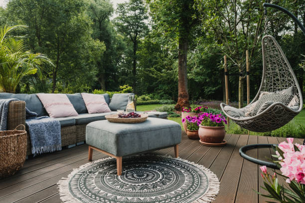 Garden patio decorated with Scandinavian wicker sofa and coffee table Garden patio decorated with Scandinavian wicker sofa and coffee table garden stock pictures, royalty-free photos & images