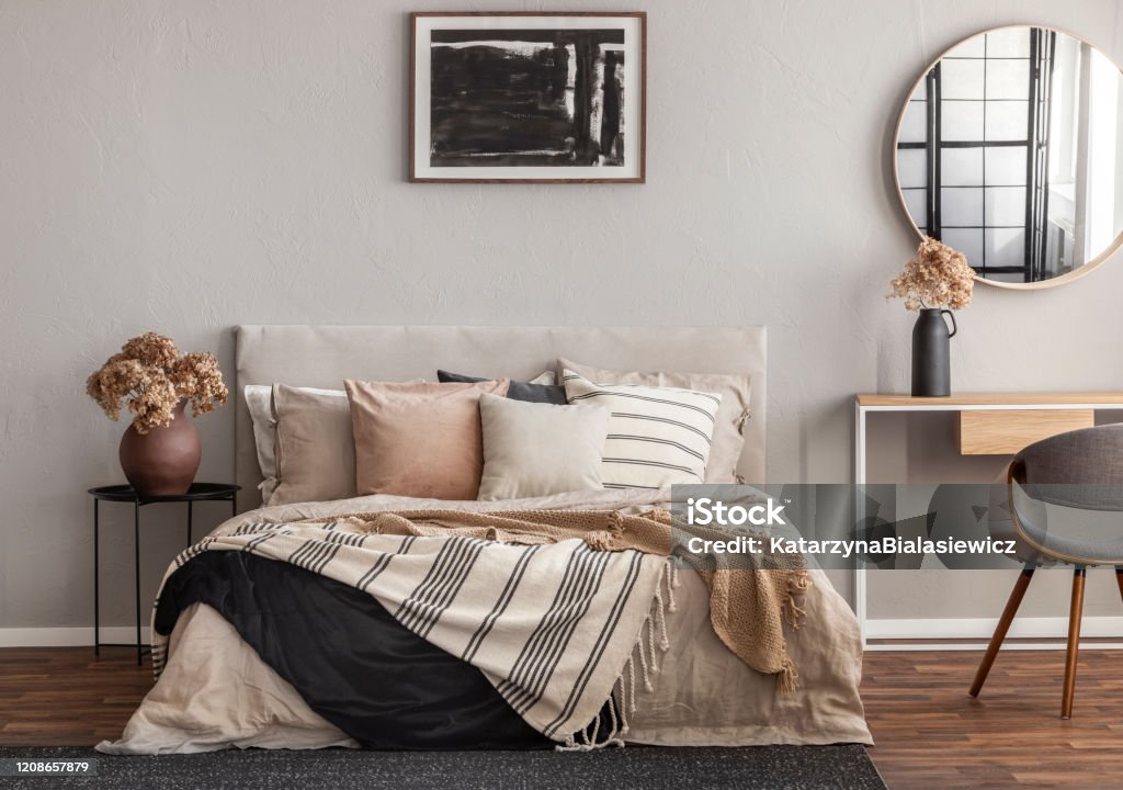 Abstract black oil painting in frame on empty beige wall of cozy bedroom Bedroom Stock Photo