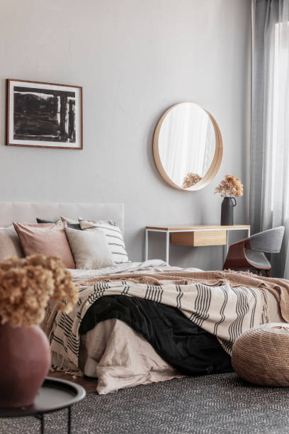istock Cozy pillows on comfortable big king size bed in bright bedroom interior in elegant apartment 1208657881