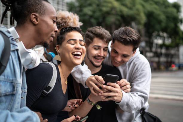 istock Group of friends using smartphone in the city 1208657914