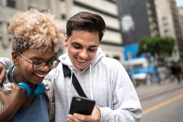 istock Couple using smartphone in the city 1208657920