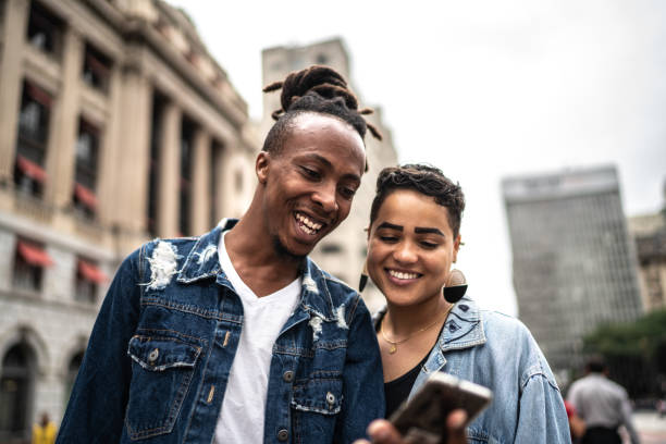 istock Couple using smartphone in the city 1208658086