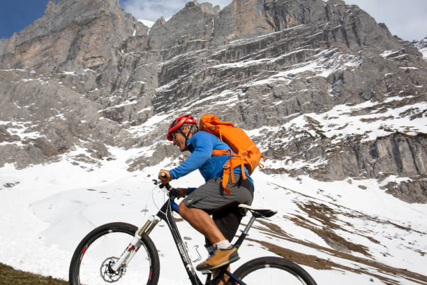 istock Mountain biker ascends steep mountainside view of the Eiger behind 1208658467