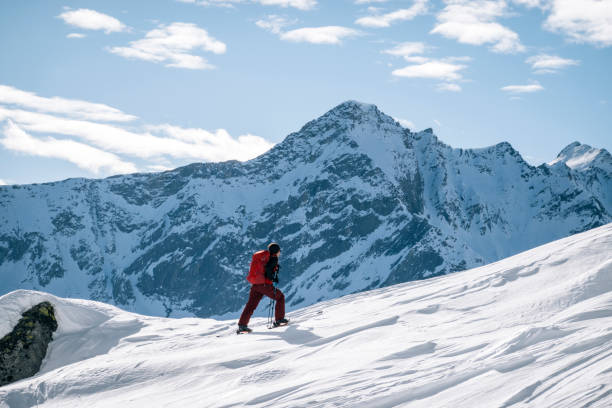 istock Ski mountaineer ascends snowy mountain ridge line 1208659077