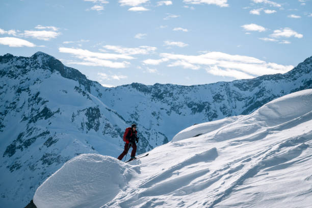 istock Ski mountaineer ascends snowy mountain ridge line 1208659079