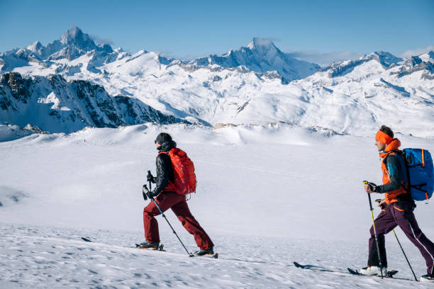 istock Ski mountaineers ascend snowy mountain ridge line 1208659118
